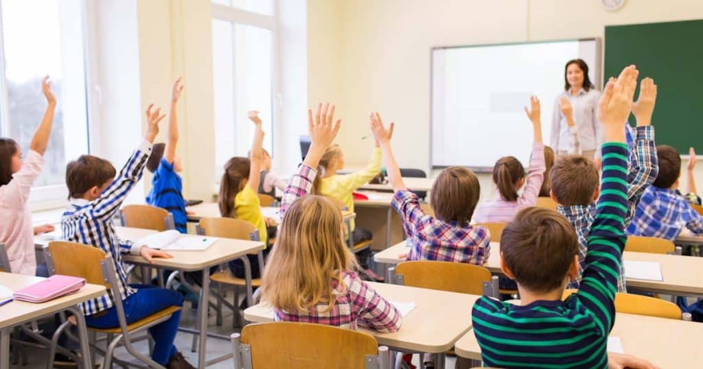 school children learning with teacher